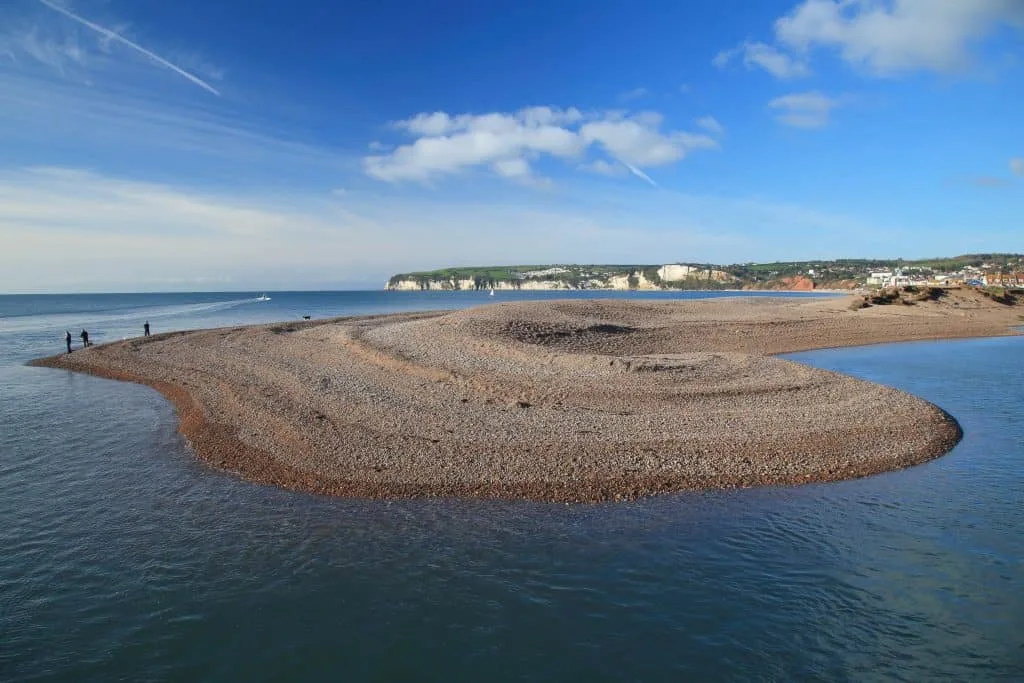 The shingle spit at the end of Seaton Beach in East Devon where the river flows into the sea