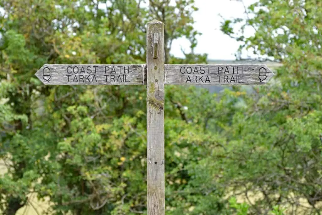 A wooden sign on the Southwest Coast Path / Tarka Trail public footpath and cycleway. Taken between Bideford and Barnstaple in North Devon England