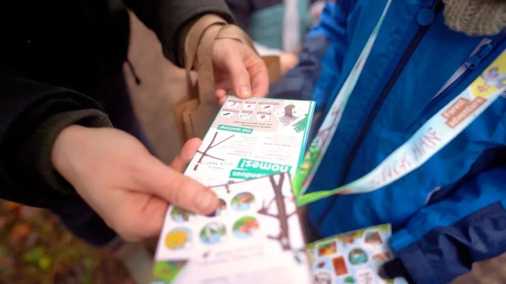Hands hold a Stick Man passport