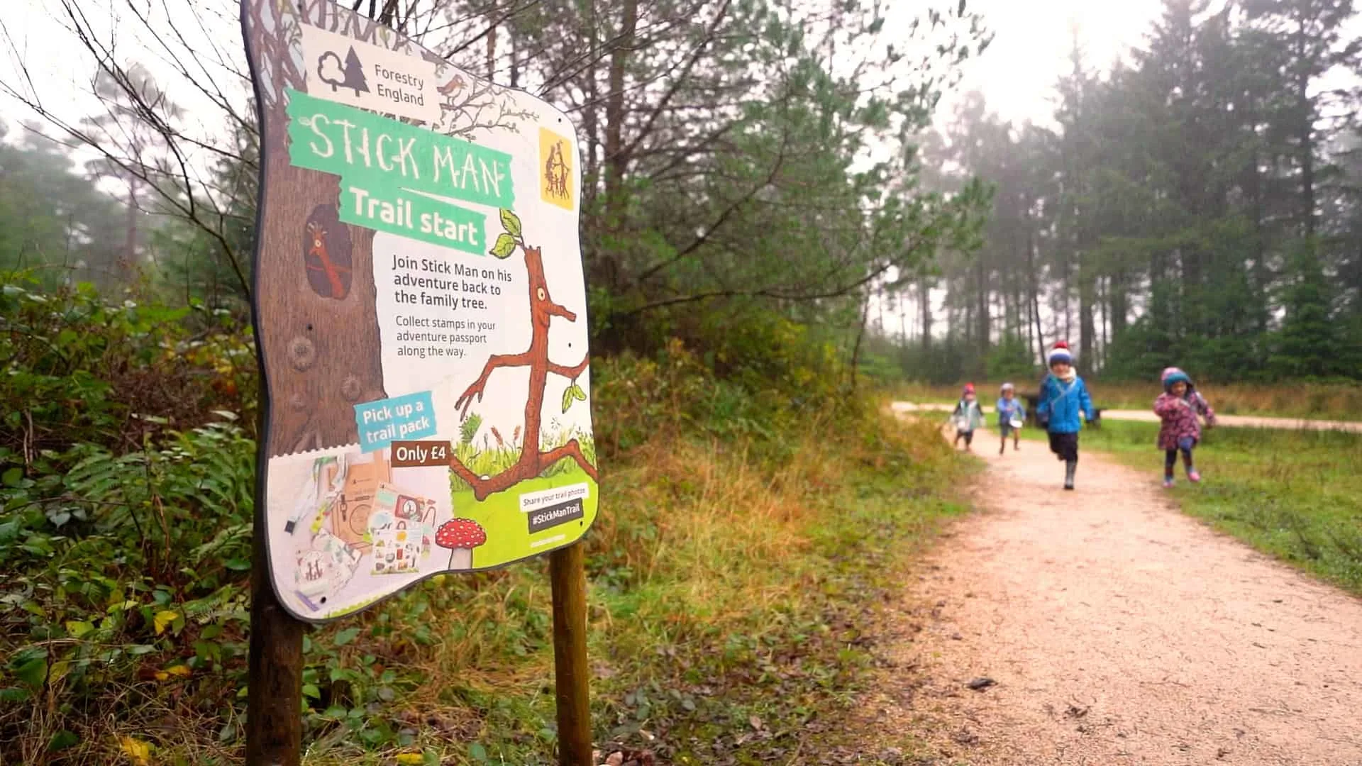 Stick Man activity trail information board on woodland