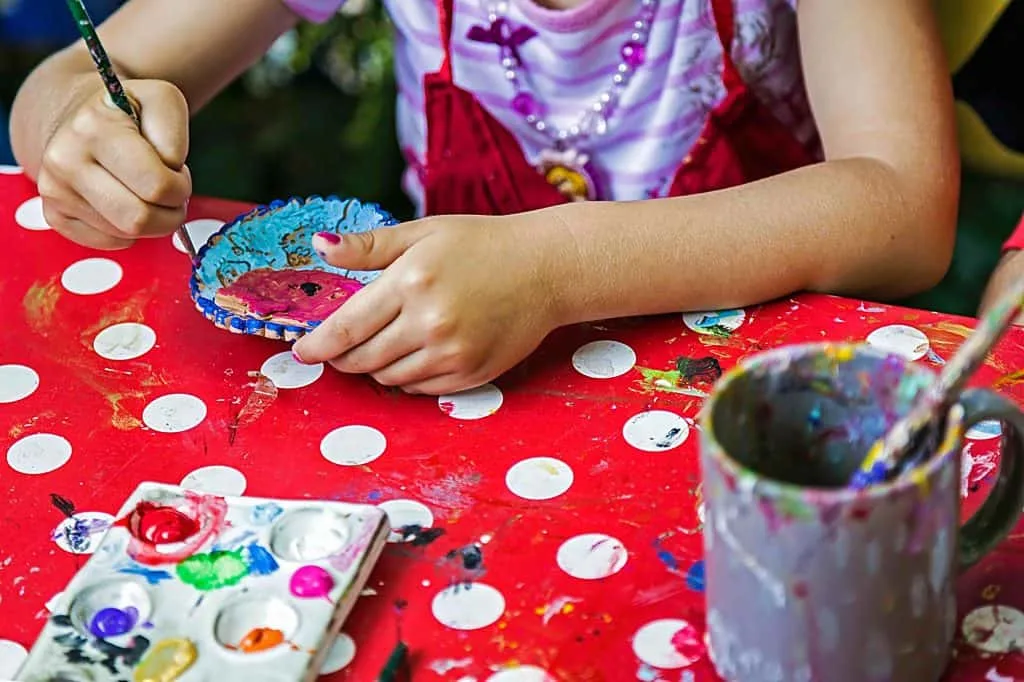 Children painting pottery at a workshop