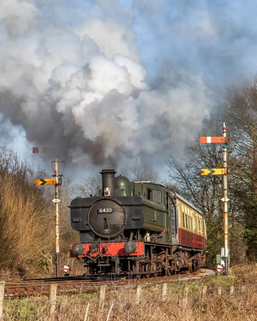 Resorted 1930s 6430 steam locomotive steaming along the track at Buckfastleigh 