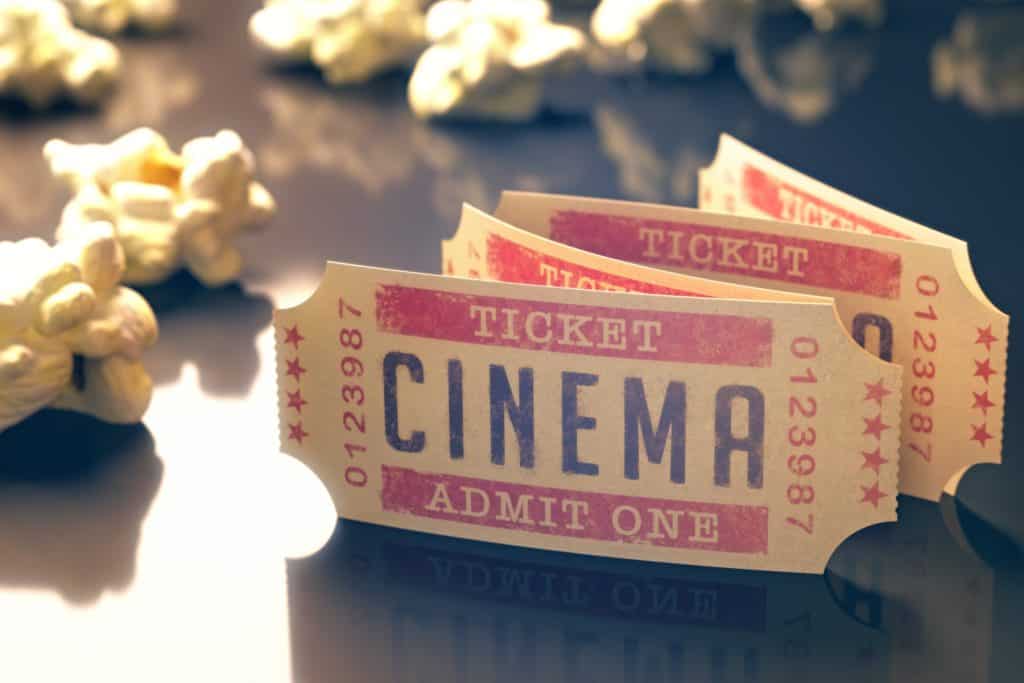 Entry ticket to the cinema with popcorn around. Clipping path included.