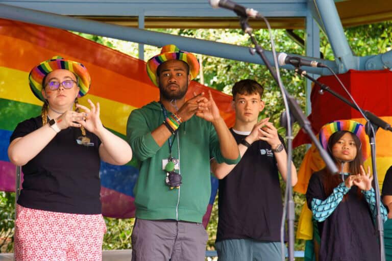 Members of the Deaf Academy performing on stage at Exmouth Pride