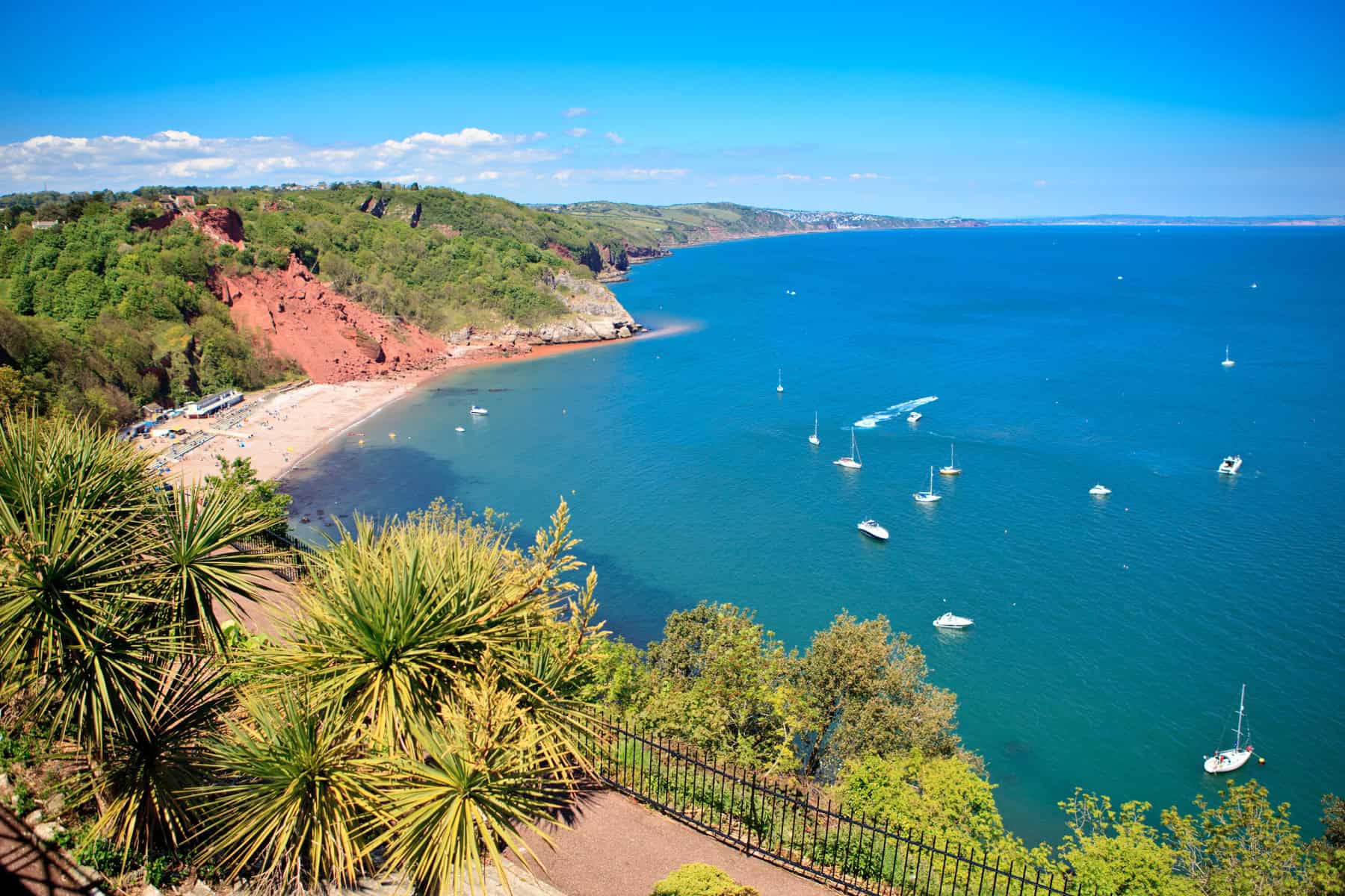 A view of Oddicombe Bay from Babbacombe Downs. It is a summers day and the sea and sky are bright blues