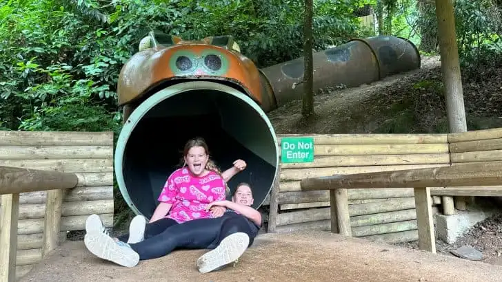 My daughters in a pile at the bottom of a snake slide at River Dart Country Park