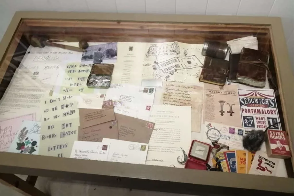 A glass topped cabinet containing props from the TV show