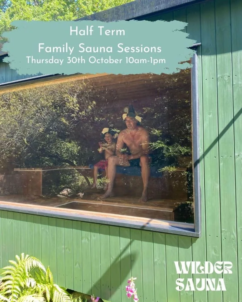 Family inside Wilder's sauna., viewed through the window that looks out onto the river and woodlands