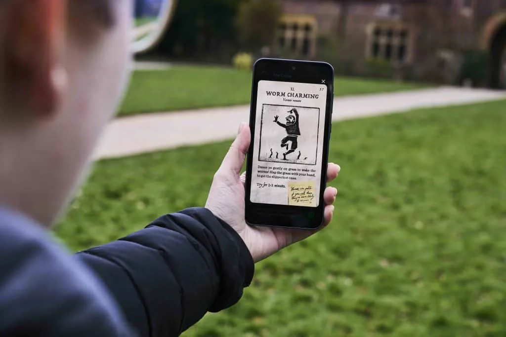 Worm charming challenge shown on a smart phone screen at a National Trust property