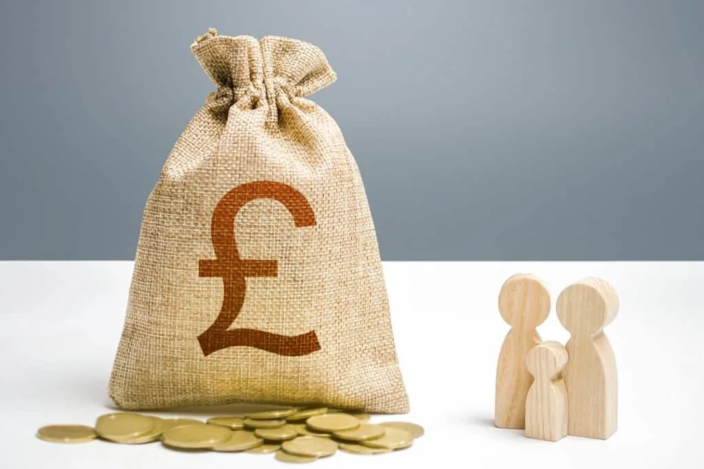 British pounds sterling money bag with money and family figurines. 