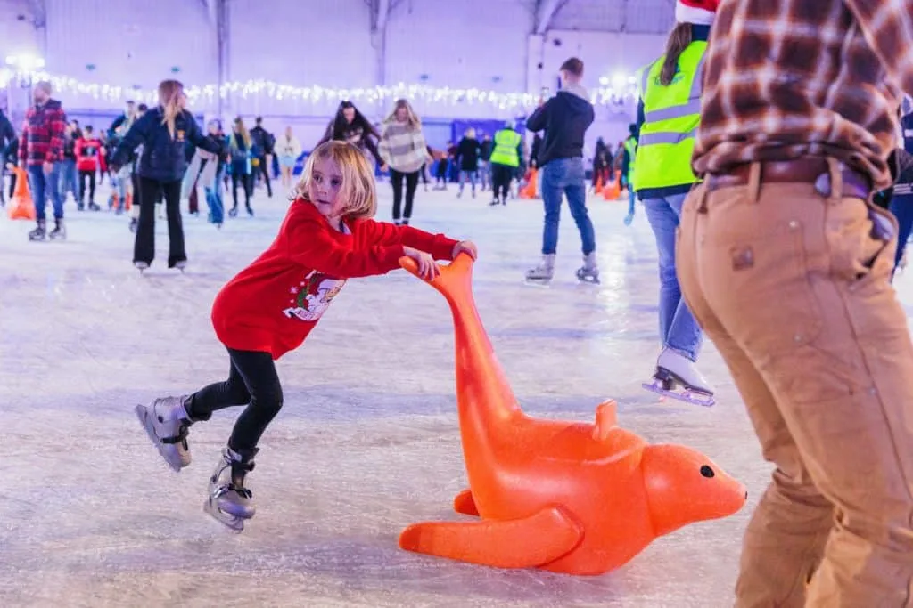 Child using skating aid on ice rink at Westpoint near Exeter
