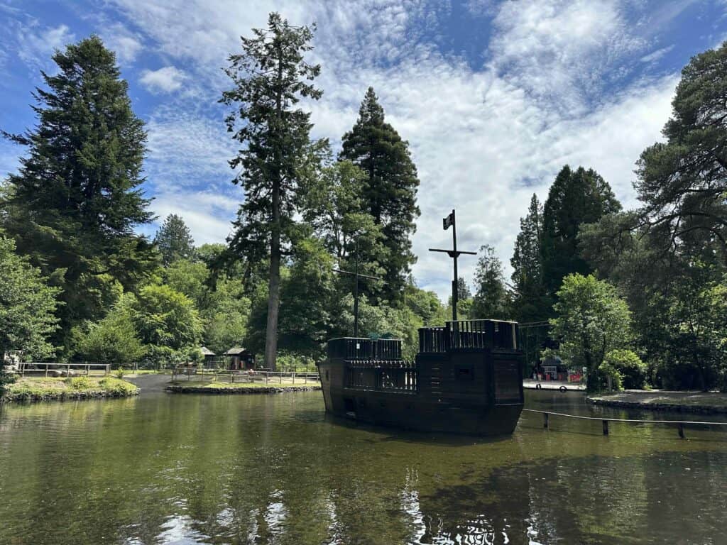Wooden pirate shop in the swimming lake at River Dart Country Park