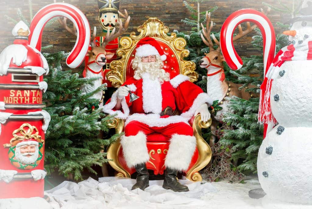 Santa sat in his grotto at Cofton Holidays surrounded by candy canes, Christmas trees and a post box