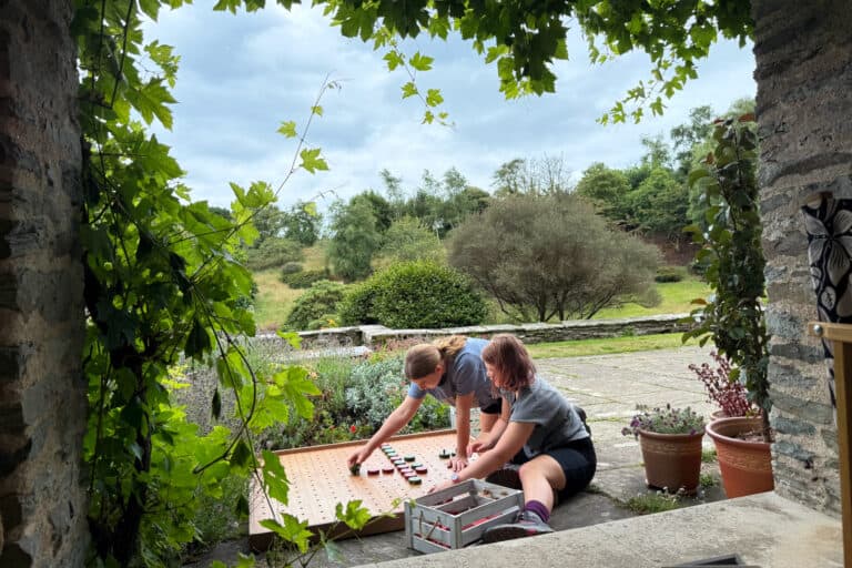 My girls playing with an old fashioned board game at Coleton Fishacre in South Devon