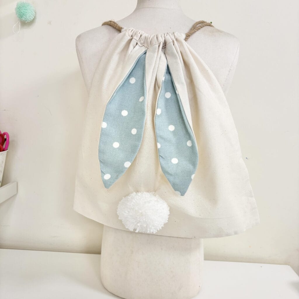A child's draw string bag decorated as a bunny