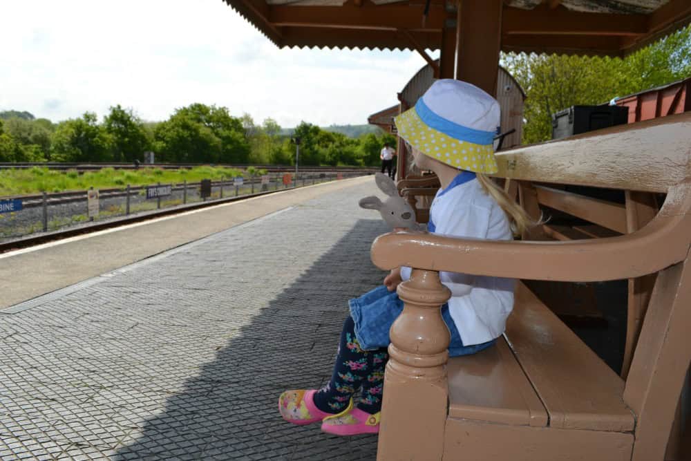 Toddler sat on South Devon Railway station bench at Totnes