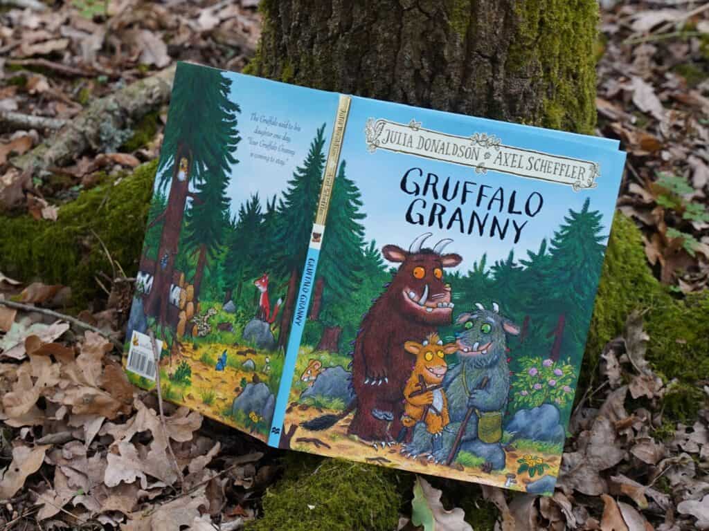 A photo of the Gruffalo Granny book propped against a tree on the forest floor